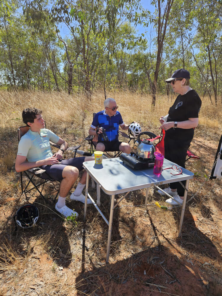 Our first roadside breakfast The first of many meals eaten beside the road. Table and chairs out, food on the table and everyone refuelling before Bob and Tom continued towards Willare. Our first roadside breakfast The first of many meals eaten beside the road. Table and chairs out, food on the table and everyone refuelling before Bob and Tom continued towards Willare.