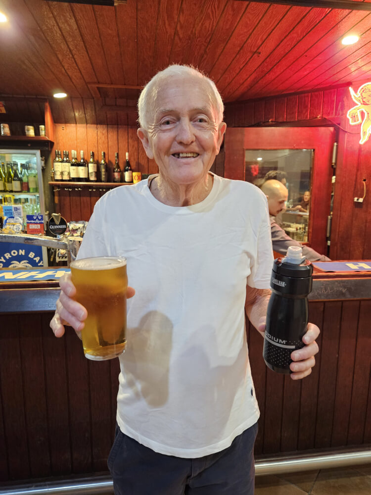 Bob’s end-of-day XXXX Bob Montgomery smiling and holding a glass of XXXX beer at Fitzroy River Lodge