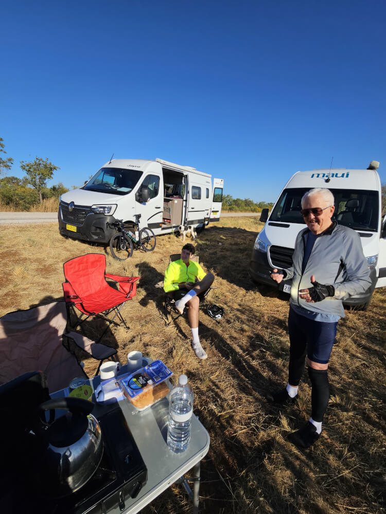 Second breakfast on the road Bob and Tom beside the support vans during a roadside breakfast in the Kimberley
