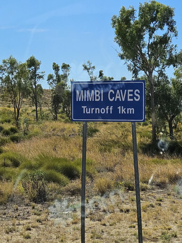 Road sign showing Mimbi Caves turnoff one kilometre ahead