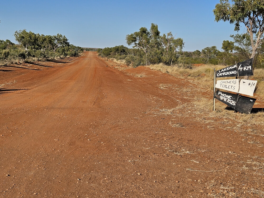 Simple Instructions at Larrawa Red dirt station road and directional sign at Larrawa Station