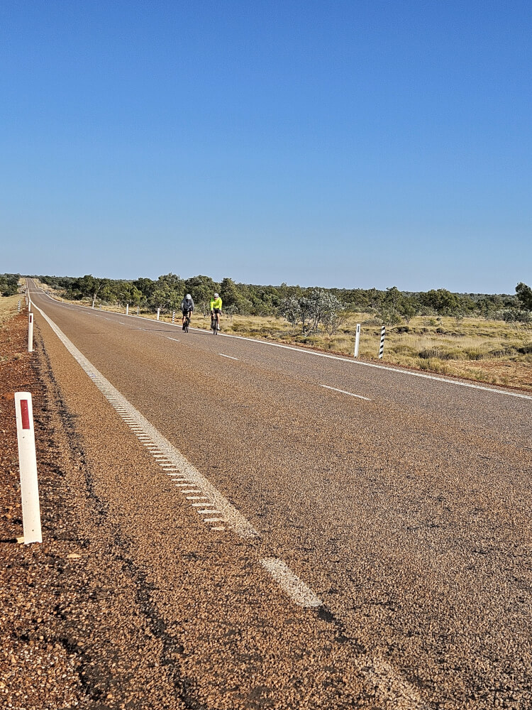 Here Come the Boys Bob Montgomery and Tom Malcolm cycling towards the support van on the Great Northern Highway