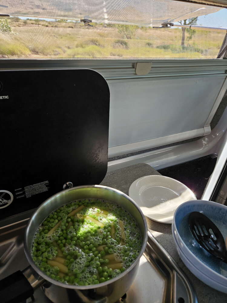 Roadside Lunch Pasta, peas and tuna cooking inside the support van