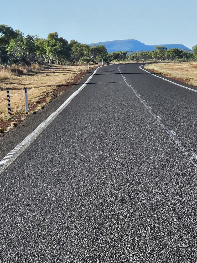 The Road Into Halls Creek Great Northern Highway curving towards ranges near Halls Creek