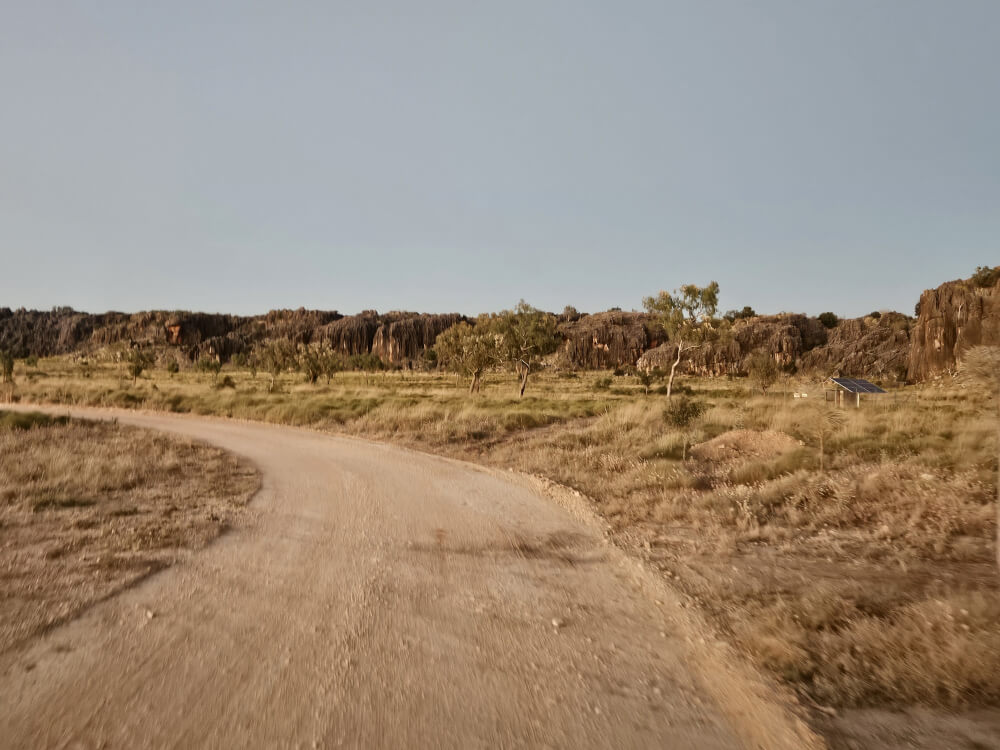 Mimbi in the Morning Light Gravel road curving through rocky Kimberley country near Mimbi Caves