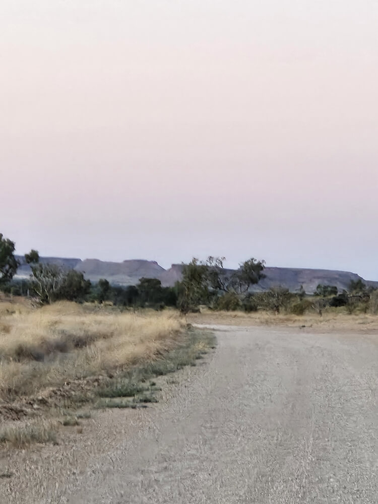 Morning Colours at Mimbi Pale pink morning sky above rocky ranges near Mimbi Caves