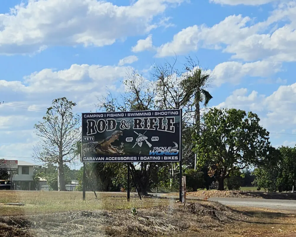 Rod & Rifle Roadside Sign | Katherine, Northern Territory Rod & Rifle roadside advertising sign featuring a crocodile and outdoor recreation supplies near Katherine, Northern Territory.