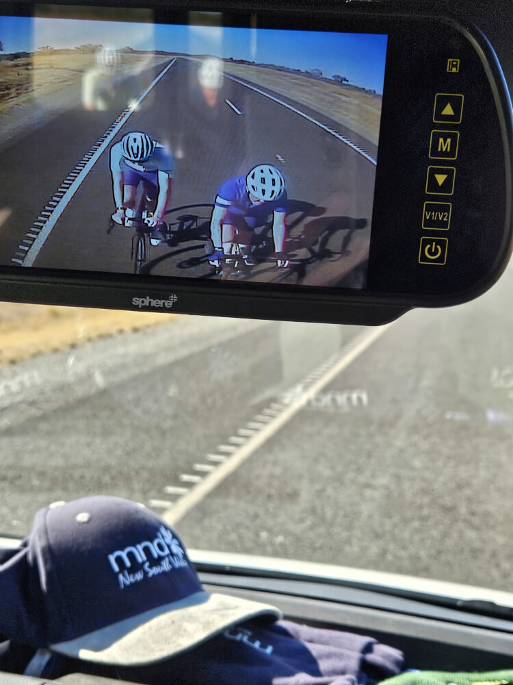 Bob and Tom Behind the Support Van Rear-view camera showing Bob and Tom cycling behind the support van