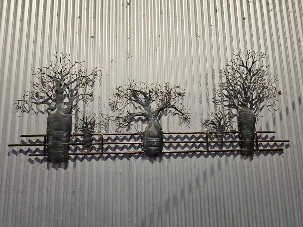 Metal Wall Art in Kununurra Decorative metal tree artwork displayed on a corrugated wall