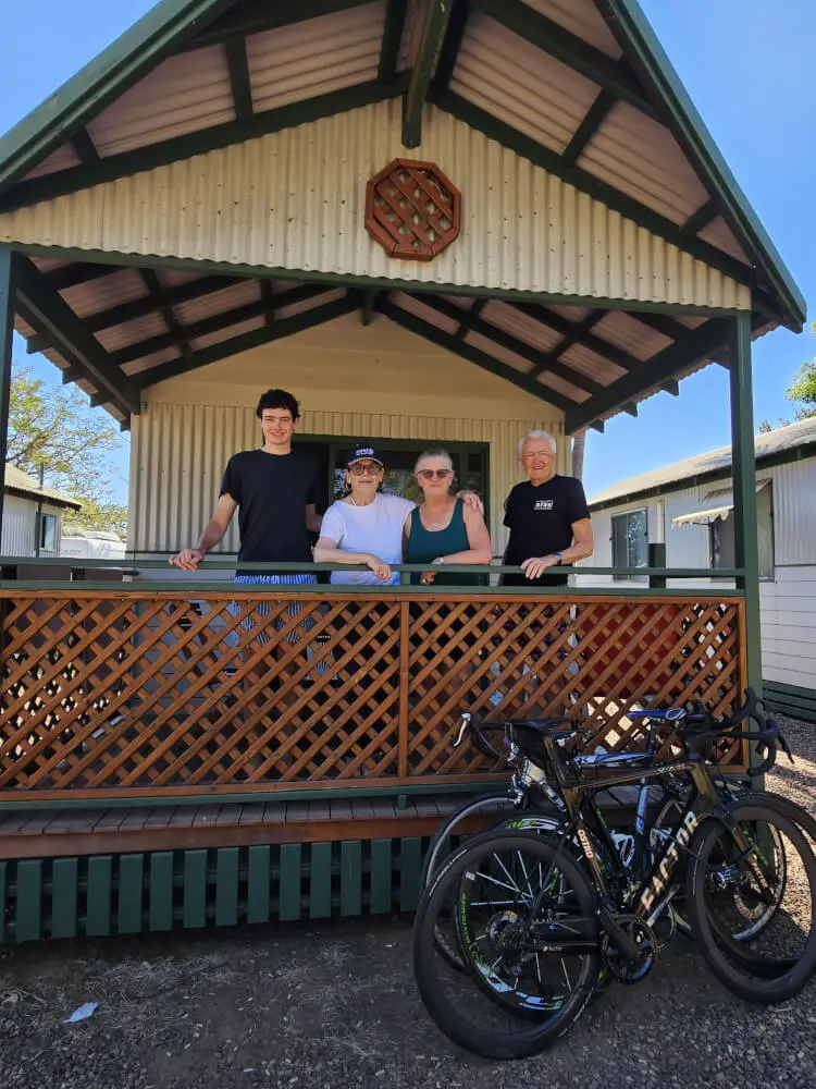 Our Kununurra Neighbour Tom, a woman, Jenny and Bob standing on the verandah of a Kununurra cabin