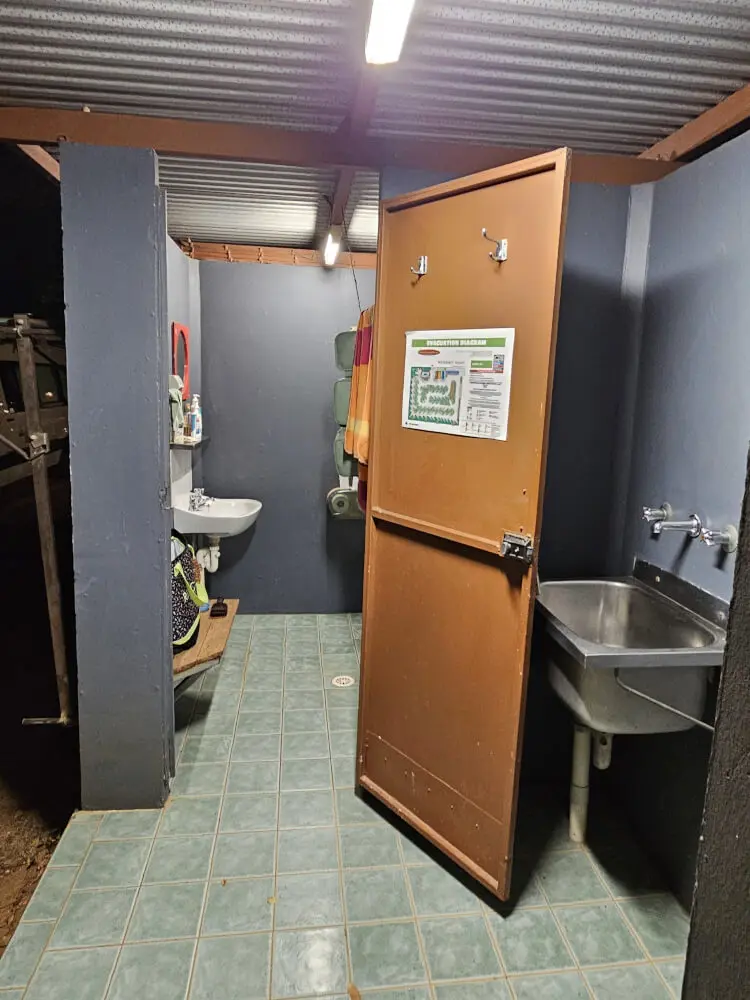 The Campground Amenities Open doorway to a campground amenities block showing tiled flooring, sinks and shower facilities