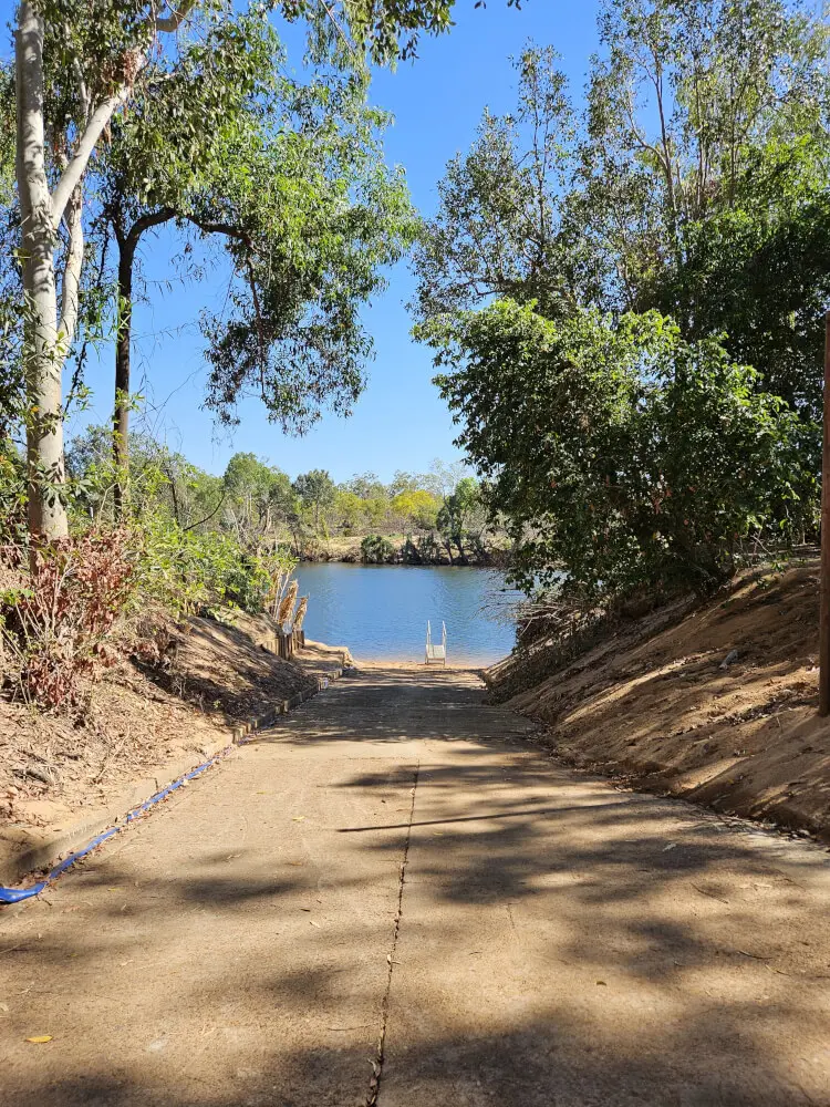 Down to the Water Concrete boat ramp leading down to the water through trees at Nitmiluk National Park