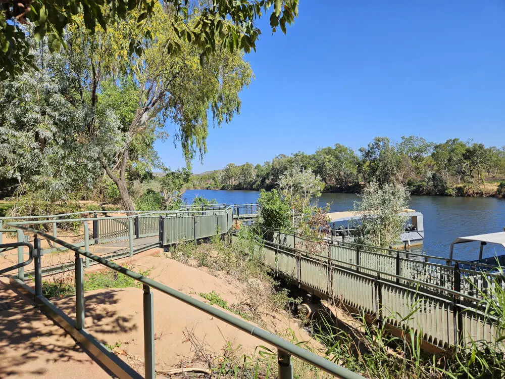 Access to the Gorge Boats Metal ramps and railings leading towards boats moored beside the river